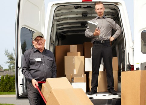 Removalists loading furniture for a house move in Holland Park