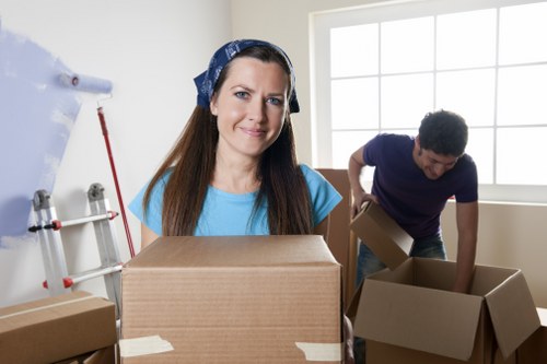 Local office movers handling desks and boxes near Holland Park