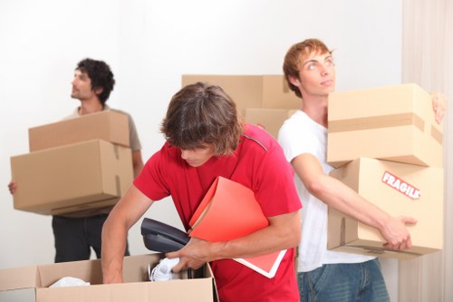 Furniture and boxes being transported by local movers in Holland Park