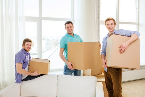 Professional movers handling household items in a West London property
